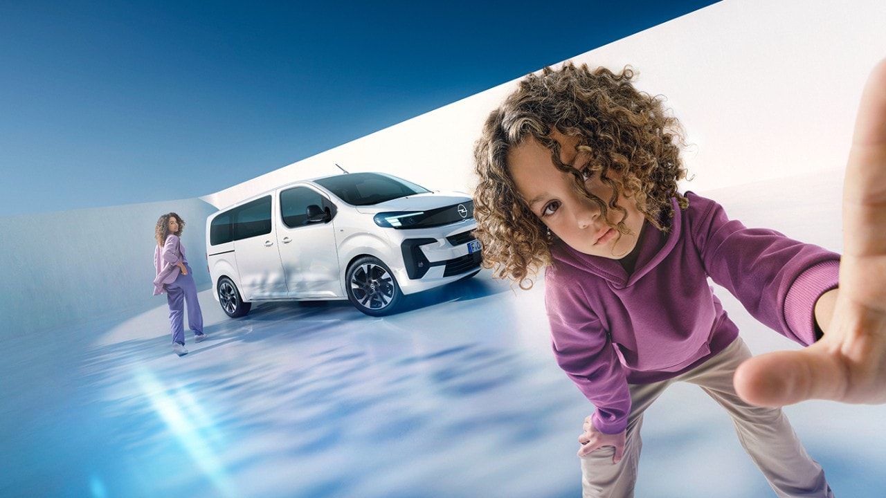  Woman and boy with a white Opel Zafira in the background